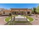 A spacious backyard has a pergola, patio, and decorative landscaping with low-maintenance turf at 1834 E Scorpio Pl, Chandler, AZ 85249