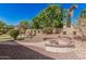 Desert landscaped backyard with a fire pit area and a pergola at 1834 E Scorpio Pl, Chandler, AZ 85249