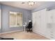 This bedroom features a Murphy bed, built-in shelving, and desk with a window at 1834 E Scorpio Pl, Chandler, AZ 85249