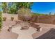 Stone fire pit area with seating, pavers, and desert landscaping at 1834 E Scorpio Pl, Chandler, AZ 85249