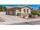 View of the attached three-car garage and landscaped side yard of the single-story home at 1834 E Scorpio Pl, Chandler, AZ 85249