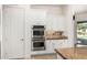 Kitchen boasts stainless steel double ovens and white cabinets at 1834 E Scorpio Pl, Chandler, AZ 85249