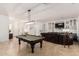 Open-concept living area featuring a pool table and custom built-ins for entertainment and relaxation at 1834 E Scorpio Pl, Chandler, AZ 85249