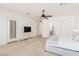 Bright main bedroom with ceiling fan, TV, and neutral carpet flooring at 1834 E Scorpio Pl, Chandler, AZ 85249