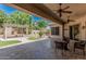 A covered patio features a decorative pergola, outdoor seating and easy-care turf at 1834 E Scorpio Pl, Chandler, AZ 85249