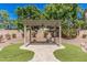 A beautiful pergola with pavers and artificial grass in a landscaped backyard at 1834 E Scorpio Pl, Chandler, AZ 85249