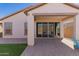 Backyard featuring a covered patio with tile flooring, a manicured artificial lawn, and desert landscaping at 19726 W Woodlands Ave, Buckeye, AZ 85326