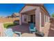 Backyard with covered patio, desert landscaping, pavers, and outdoor seating at 19726 W Woodlands Ave, Buckeye, AZ 85326