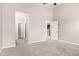 Bright, neutral bedroom with new carpet, open doors to kitchen and bedrooms at 19726 W Woodlands Ave, Buckeye, AZ 85326