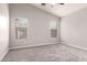 Neutral bedroom with carpet, ceiling fan, and two windows for lots of natural light at 19726 W Woodlands Ave, Buckeye, AZ 85326