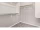 Walk-in closet provides ample storage with built-in shelving and rod for hanging clothes at 19726 W Woodlands Ave, Buckeye, AZ 85326