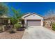 Charming single-story home featuring a desert-landscaped front yard and attached two-car garage at 19726 W Woodlands Ave, Buckeye, AZ 85326