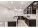 Kitchen with granite countertops, stainless steel appliances, dark cabinets, and an island sink at 19726 W Woodlands Ave, Buckeye, AZ 85326