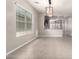 Open-concept living space features lots of natural light, tile floors and an attractive chandelier at 19726 W Woodlands Ave, Buckeye, AZ 85326