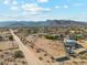 Wide aerial shot showing the surrounding desert landscape, neighborhood, and mountain views from the property at 20041 W Pasadena Ave, Litchfield Park, AZ 85340