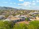 Aerial view of the backyard showing patio, balcony, landscaping and distant mountain views at 20041 W Pasadena Ave, Litchfield Park, AZ 85340