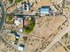 Overhead view of a home on a large lot, featuring desert landscaping, various structures, and ample space at 20041 W Pasadena Ave, Litchfield Park, AZ 85340