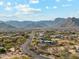 Scenic aerial perspective of a desert home with a backdrop of impressive mountain vistas at 20041 W Pasadena Ave, Litchfield Park, AZ 85340