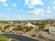 Expansive aerial view of a desert home with mountain views and a lush, landscaped yard at 20041 W Pasadena Ave, Litchfield Park, AZ 85340