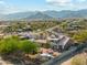 Aerial view of a desert home with a tile roof, extensive landscaping and outdoor seating, surrounded by scenic views at 20041 W Pasadena Ave, Litchfield Park, AZ 85340
