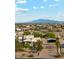 Aesthetic aerial shot of a desert home featuring mountain views and a meticulously maintained yard at 20041 W Pasadena Ave, Litchfield Park, AZ 85340