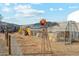 View of outdoor chicken coop with rusted windmill feature at 20041 W Pasadena Ave, Litchfield Park, AZ 85340
