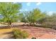 Large brick patio with a swing and comfortable seating under the shade of mature trees at 20041 W Pasadena Ave, Litchfield Park, AZ 85340