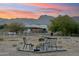Desert backyard seating area with mountain views, including an outdoor table and chairs in natural surroundings at 20041 W Pasadena Ave, Litchfield Park, AZ 85340