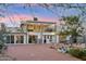 Expansive backyard with a covered patio, balcony, brick pavers, lush vegetation, and outdoor dining and grilling area at 20041 W Pasadena Ave, Litchfield Park, AZ 85340