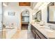 Elegant bathroom with dual sinks, soaking tub, and view of the main bedroom at 20041 W Pasadena Ave, Litchfield Park, AZ 85340