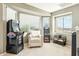 Entertaining bonus room featuring arcade games, comfortable seating, and natural light from multiple windows at 20041 W Pasadena Ave, Litchfield Park, AZ 85340