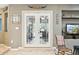 Inviting entryway with neutral tones, unique wall decor, and glass French doors offering a glimpse into the adjacent room at 20041 W Pasadena Ave, Litchfield Park, AZ 85340
