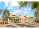 Inviting desert home featuring a three-car garage, paver driveway, and beautifully landscaped front yard at 20041 W Pasadena Ave, Litchfield Park, AZ 85340