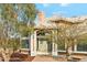 Close up view of a home's front entrance, featuring a detailed doorway and desert landscaping at 20041 W Pasadena Ave, Litchfield Park, AZ 85340