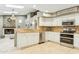 Well-equipped kitchen with stainless steel appliances, white cabinetry, and an open layout at 20041 W Pasadena Ave, Litchfield Park, AZ 85340