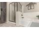 Modern bathroom featuring a walk-in shower, tub, and decorative wall art at 21152 W Sunrise Ln, Buckeye, AZ 85396