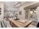 Open dining room featuring a wood table and seating for six, adjacent to a sliding glass door and view of the kitchen at 21152 W Sunrise Ln, Buckeye, AZ 85396