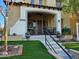 Charming home exterior with a welcoming front porch, stylish decor, and a well-manicured lawn at 21152 W Sunrise Ln, Buckeye, AZ 85396