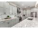 Close up of kitchen with granite countertops, stainless steel appliances, gray cabinetry and subway tile backsplash at 21152 W Sunrise Ln, Buckeye, AZ 85396