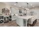 Spacious kitchen with a large center island, stainless steel appliances, pendant lights, and ample gray cabinetry at 21152 W Sunrise Ln, Buckeye, AZ 85396