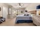 Comfortable main bedroom features a ceiling fan and shuttered windows at 21152 W Sunrise Ln, Buckeye, AZ 85396