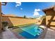 Refreshing swimming pool in a private backyard featuring artificial turf, perfect for outdoor enjoyment at 21152 W Sunrise Ln, Buckeye, AZ 85396