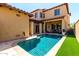 Inviting backyard pool with patio seating and lush green turf, perfect for relaxing and entertaining at 21152 W Sunrise Ln, Buckeye, AZ 85396