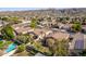 Expansive aerial view showcases a community with lush greenery, swimming pools, and beautiful mountain views at 2116 E Beautiful Ln, Phoenix, AZ 85042