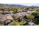 This aerial view highlights a well-maintained neighborhood with tree-lined streets and scenic mountain backdrop at 2116 E Beautiful Ln, Phoenix, AZ 85042