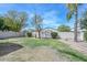 Large backyard featuring block wall, trees and partial grass coverage at 2116 E Beautiful Ln, Phoenix, AZ 85042