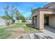 Landscaped backyard featuring covered patio, trees and block wall at 2116 E Beautiful Ln, Phoenix, AZ 85042