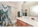 Bathroom with sink, mirror and toilet, featuring colorful octopus-themed shower curtain at 2116 E Beautiful Ln, Phoenix, AZ 85042