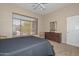 Bedroom with large window providing ample natural light, complemented by neutral walls at 2116 E Beautiful Ln, Phoenix, AZ 85042