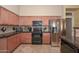 Well-equipped kitchen with stainless steel refrigerator and granite countertops at 2116 E Beautiful Ln, Phoenix, AZ 85042